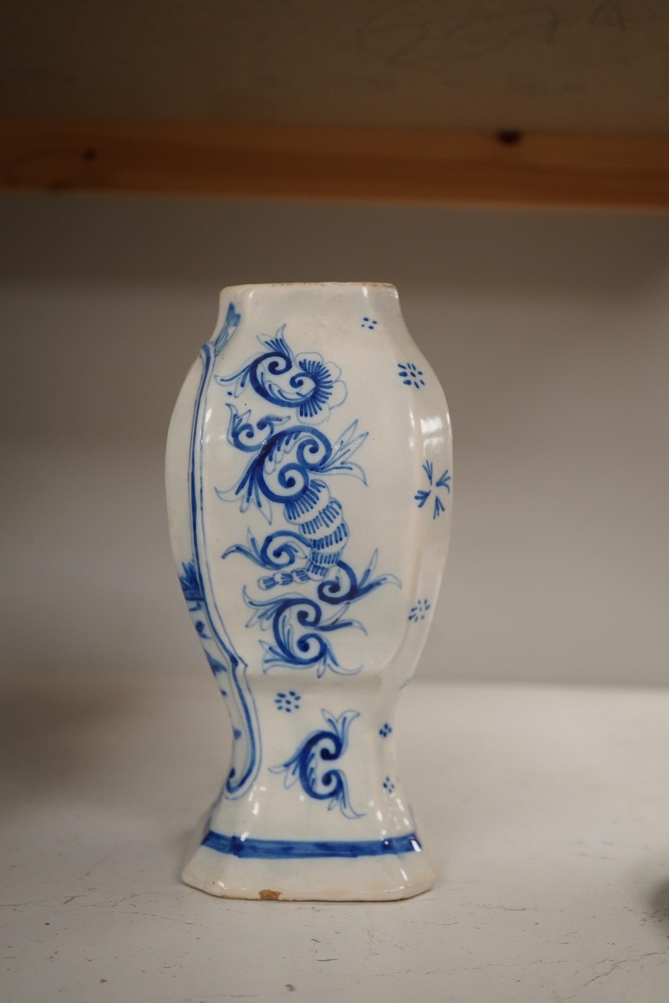 A 19th century Delft blue and white vase and a Watcombe Torquay pottery chamberstick, 19.5cm. Condition - both fair